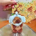 Cute brown capybara plush keychain wearing a blue elephant hat with metal buckle - Elephant Headwear 2.0