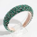 Detail of a wide baroque headband featuring green crystals on a beige inner lining - Green