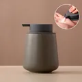 Minimalist olive green ceramic soap dispenser with a matte textured finish and pump - Rounded / Cyan Grey with Grey Pump
