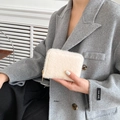 Chique crème witte faux fur mini portemonnee met gouden rits vastgehouden door model - Off-wit