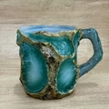 Artisanal resin coffee mug with turquoise mineral crystal texture and brown wood bark finish - Green Wave