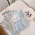 Detail of blue quilted handbag with floral patterns and a simple wish label - Blue Plaid Floral