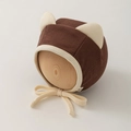 Detail of newborn baby hat with cat ears, ribbed knit texture and chin straps - 0-12 Months / Coffee