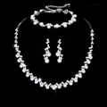 Elegant silver bridal jewelry set with pearls and rhinestones on black background - 837 Pearl Three-piece Set