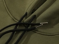 Neckline detail of an army green hoodie featuring woven drawstrings with metal tips - Army Green