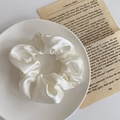 Elegant cream white satin scrunchie with smooth silk texture on a white ceramic plate - 1076D Creamy White Satin Scrunchie