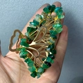 Macro detail of golden butterfly hair claw clip with hand-wrapped green crystal stones - Green Agate Gold Butterfly