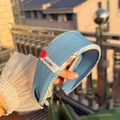 Light blue fabric headband with red button detail and woven brand label - Blue Brown Plaid Trim Wide Headband with Red Button