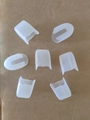 Transparent U-shaped plastic makeup brush protective covers on brown paper background - Clear