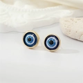 Detail of round devil's eye stud earrings with blue resin and golden metal borders - Gold Blue Glitter Eye
