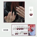 Detailed view of model wearing W008 red and white press-on nails with branch patterns - W008 Personalized Cracks