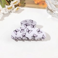 Close-up of white acrylic hair claw clip with purple butterfly print on white floral desk - 8cm Square Head / Butterfly Light Purple