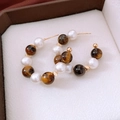 Macro detail of 16K gold plated C-shaped hoop earrings with tiger eye and white pearls - Brown-White Tiger's Eye Pearl (WE5116)