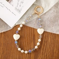 Detail of beaded phone strap with iridescent heart charms and gold lobster clasp - Crystal Heart Beaded Pendant / Gray Multi-color