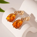 Detail of amber acrylic oval earrings with irregular gold metal knots and vintage texture - Coffee Geometric Ear Drop (Silver Pin)