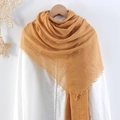 Ginger yellow crinkle cotton linen scarf with frayed edges displayed on a white shirt - Ginger Yellow