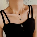 Double-layered gold necklace featuring a black four-leaf clover pendant on a female model - Black & White Double-sided Four-leaf Clover Style (8831) / Gold