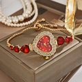 Elegant gold quartz watch with red heart-shaped dial and crystal bracelet for women - Red