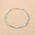 Handmade beaded bracelet with orange, blue, and clear beads on natural linen background - Style 66-Orange Blue Clear