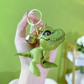 Mini green dinosaur keychain with golden metal bell and sturdy clasp for student gifts - Green