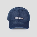 Detailed view of white CONQUER embroidery on washed navy denim baseball cap - M (56-58cm) / Dark Blue
