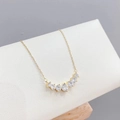 Elegant gold finish necklace featuring a curved row of seven graduated clear zircon stones - Xl-100 [gold]