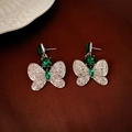 Detail of luxury emerald green butterfly earrings with crystals on a vintage velvet background - Silver Emerald Butterfly Drop Earrings (29#)