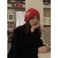 Red knit hat with pearl bow detail shown in a cozy indoor lifestyle setting - M / Red (Hat)