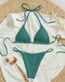 Detailed flat lay of dark green ribbed knit halter bikini with summer vacation accessories - Malachite green