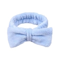 Close-up of soft light blue plush headband with a large bow for skincare and makeup - Blue
