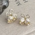 Mini lily of the valley hair claws with white enamel petals and gold bows - Creamy White (Per Piece)