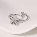 Minimalistische bloem ring met getextureerde zilveren band en open design - Staalkleur