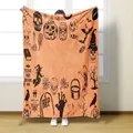 Halloween flannel blanket detail with pumpkin and skull illustrations on orange background - Orange Halloween Doodle Style / 70x100cm