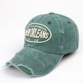 Detailed macro of vintage washed green baseball cap with distressed embroidery detail - Adjustable / Green