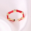 Close-up of a red enamel bamboo ring with gold plating and cubic zirconia on silk - Adjustable Open / Red