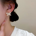 Elegant gold bow earrings with rectangular clear zircons on a model for luxury look - 1#E4196 Gold