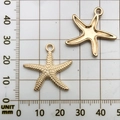 Golden starfish alloy charms for DIY bracelets shown on a millimeter grid ruler background - 1Pc Seastar 25x24mm