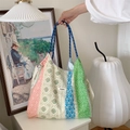 Detail of floral patchwork canvas tote bag with Sozakka brand label in a lifestyle setting - Vertical Stripe Floral Green