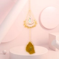 Detail of golden moon frame with natural yellow agate slice and teardrop crystal prism - Citrine