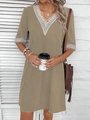 Detail of khaki V-neck dress featuring delicate white lace trim on the neckline and cuffs - S / Bottoms / Earthy Yellow