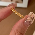 Close-up of textured gold ring with embedded small gemstones held by fingers - J5238-Gold Textured Zircon