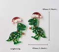 Boucles d'oreilles dinosaure de Noël en acrylique vert à paillettes avec chapeau de Noël - Dinosaure Vert avec Bonnet de Noël