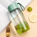 Minimalist portable plastic water bottle with green lid and strap in a fresh setting - 380ml / Green