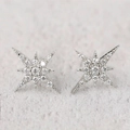 Macro view of silver star stud earrings with pavé set cubic zirconia stones - White Gold
