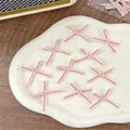 Set of 10 pink and white knitted bows for DIY crafts, 3cm size shown on white ceramic tray - Pink White Edge