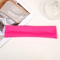 Detail of rose red elastic sports headband on a textured surface for gym and running - Rose Red