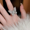 Elegant zircon butterfly open ring in silver finish worn by a model on white fur - 3# Ring-Silver