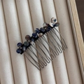 Detail of flower hair clip with blue and brown marble pattern on beige jewelry box - Dark Blue
