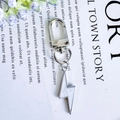 Silver metal keychain with white lightning bolt charm and spring clip attachment - White Lightning