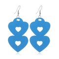 Detail of bright blue hollow double heart wooden earrings with natural grain on white surface - #11 Blue Double Heart Hollow
